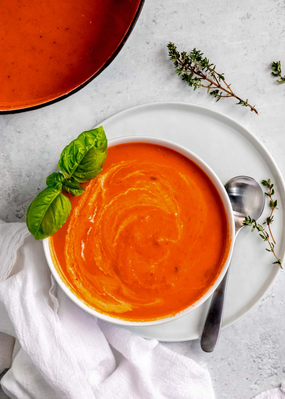 a big bowl of the BEST roasted red pepper soup with basil and heavy cream and thyme