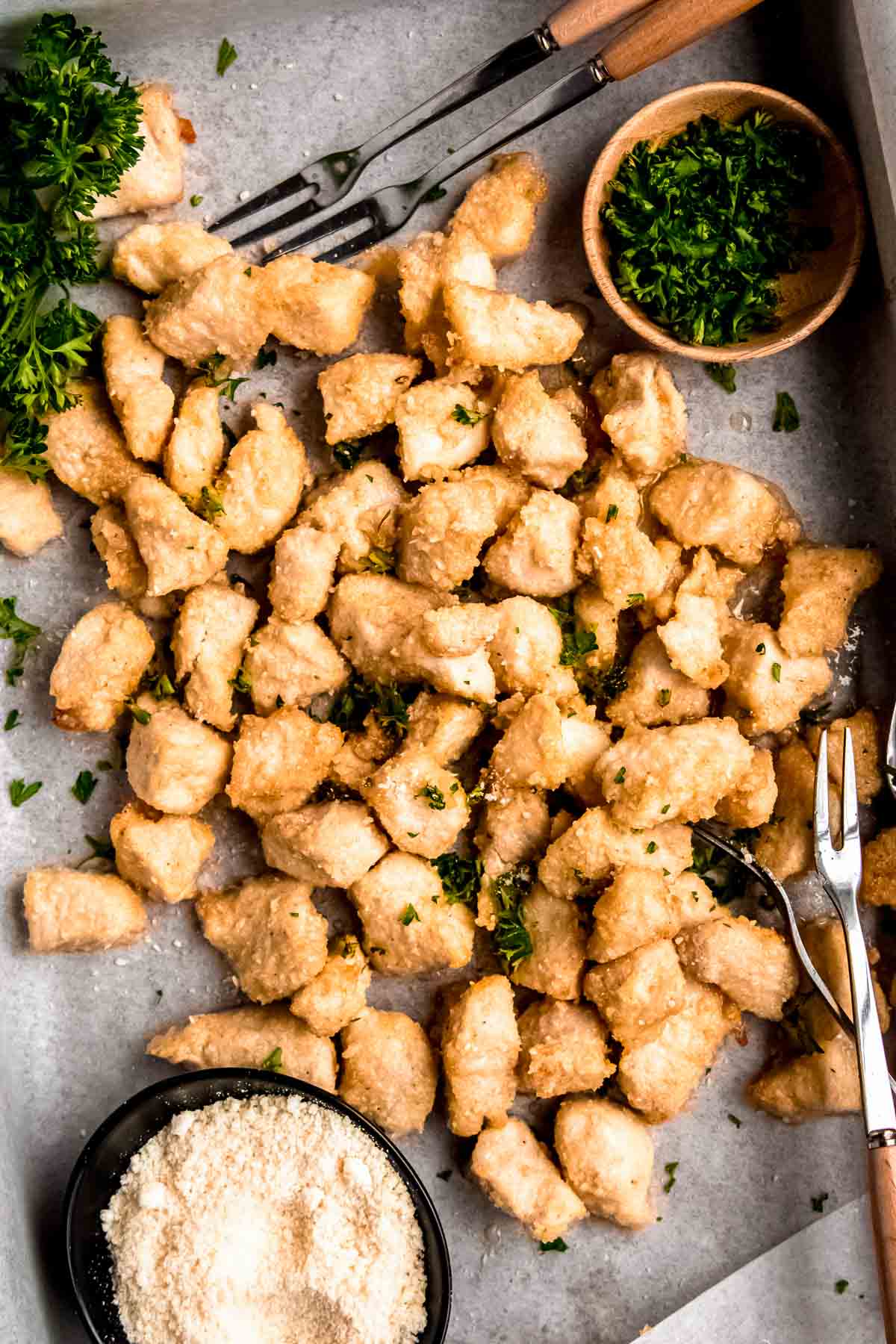 garlic parmesan chicken bites on a baking sheet