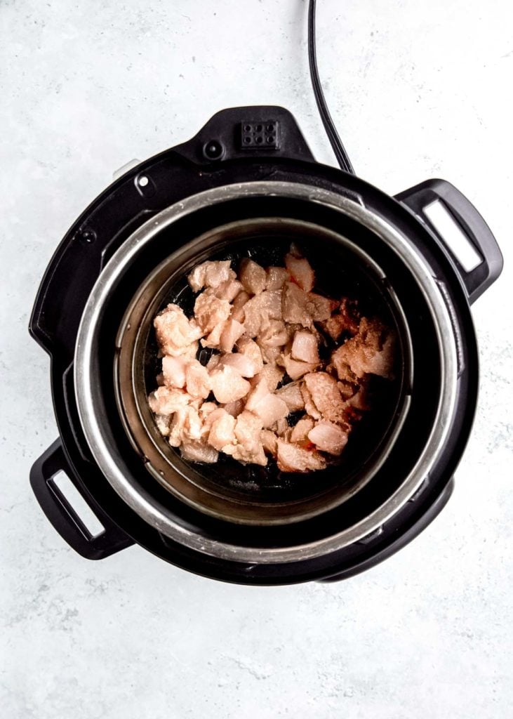 overhead shot of raw chicken in the air fryer