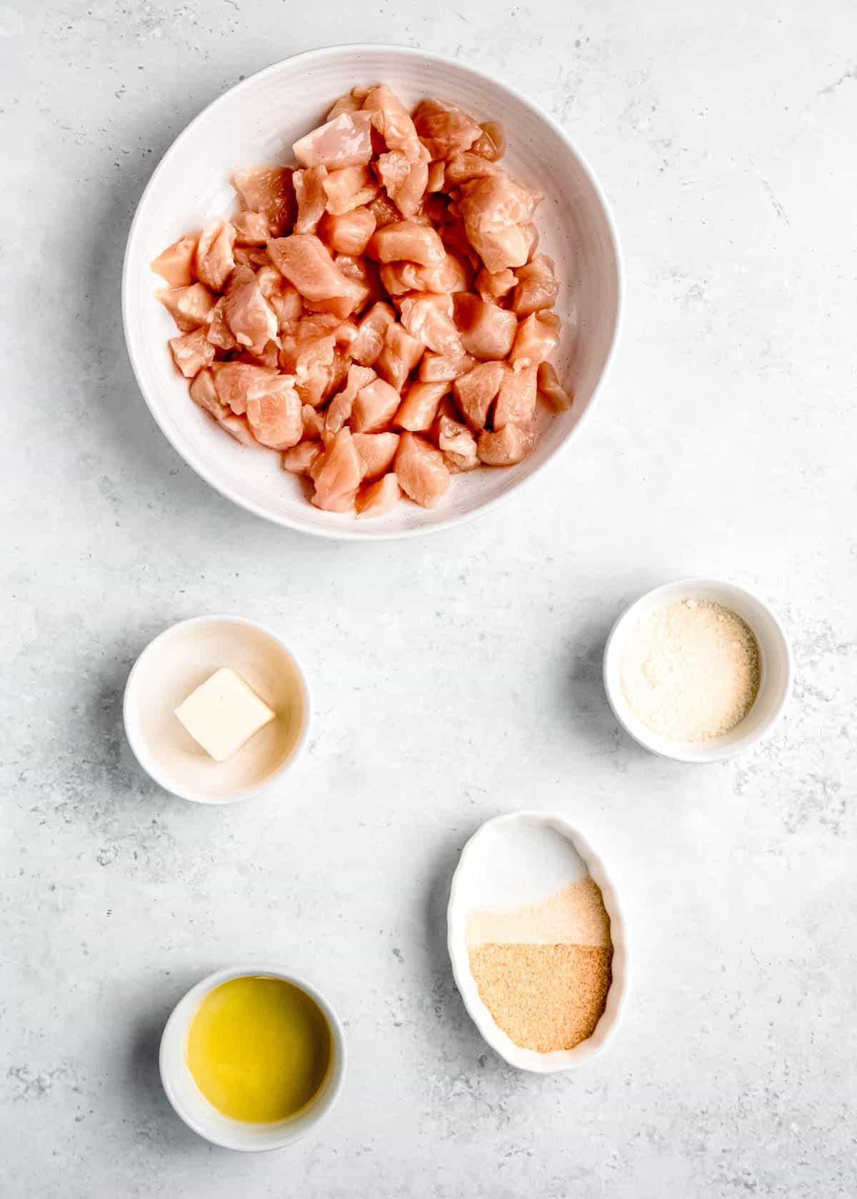 garlic parmesan chicken bite ingredients on a white table