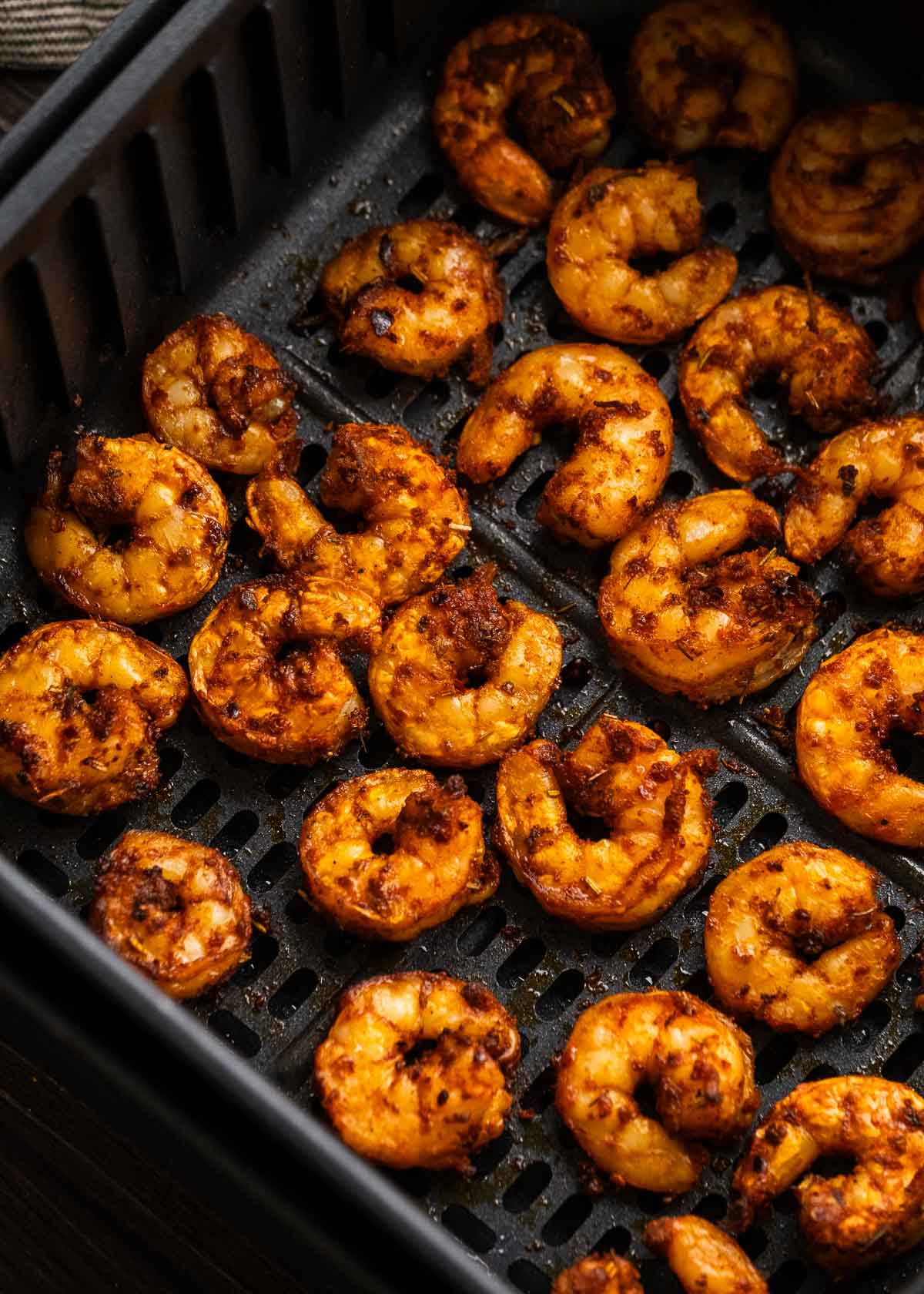 close up image of cooked shrimp in air fryer