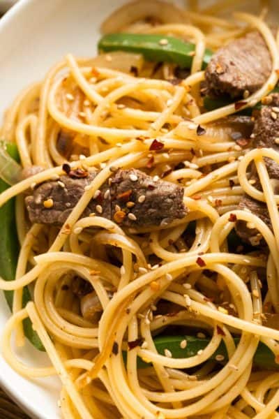 closeup overhead shot of sesame noodles with steak