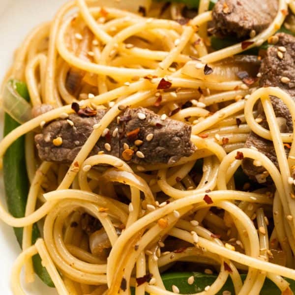 closeup overhead shot of sesame noodles with steak