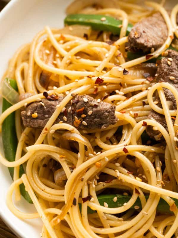 closeup overhead shot of sesame noodles with steak