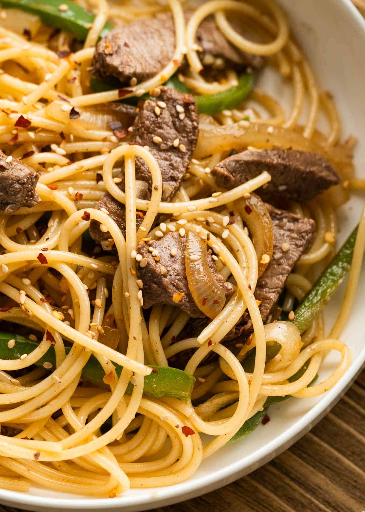 a closeup shot of sesame noodles with beef