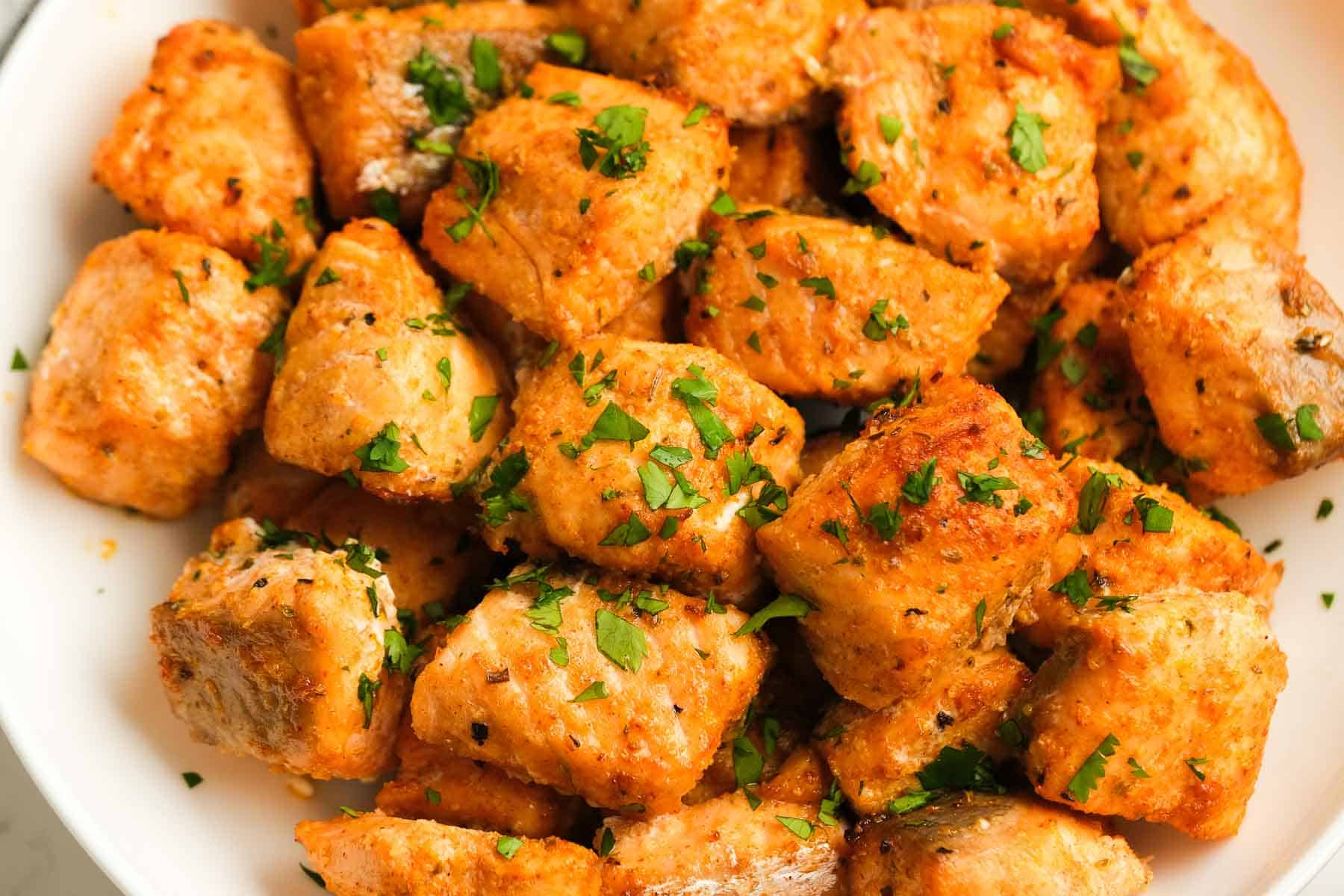 horizontal image, closeup of air fryer salmon with chopped parsley