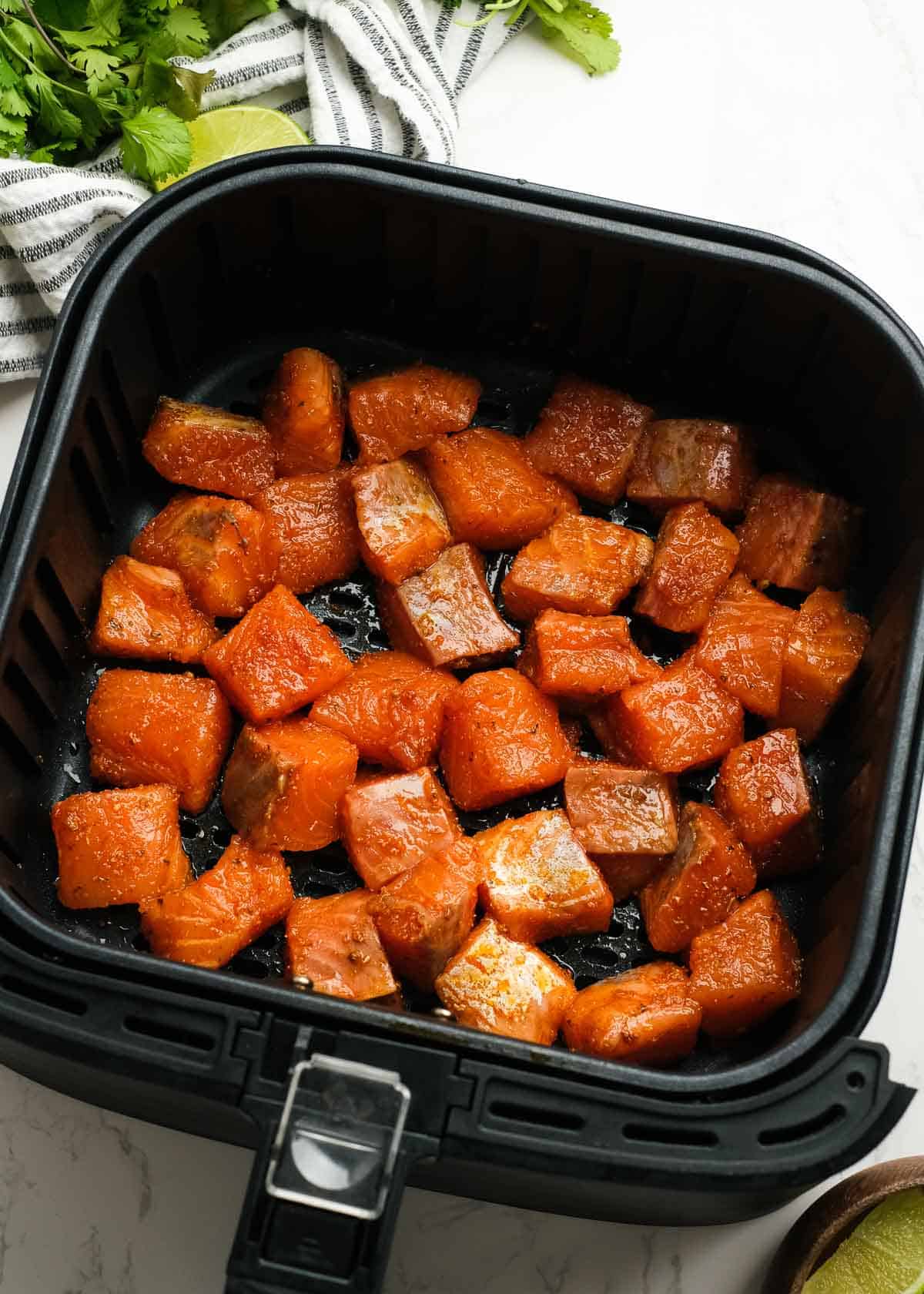 raw, seasoned salmon cubes in the air fryer