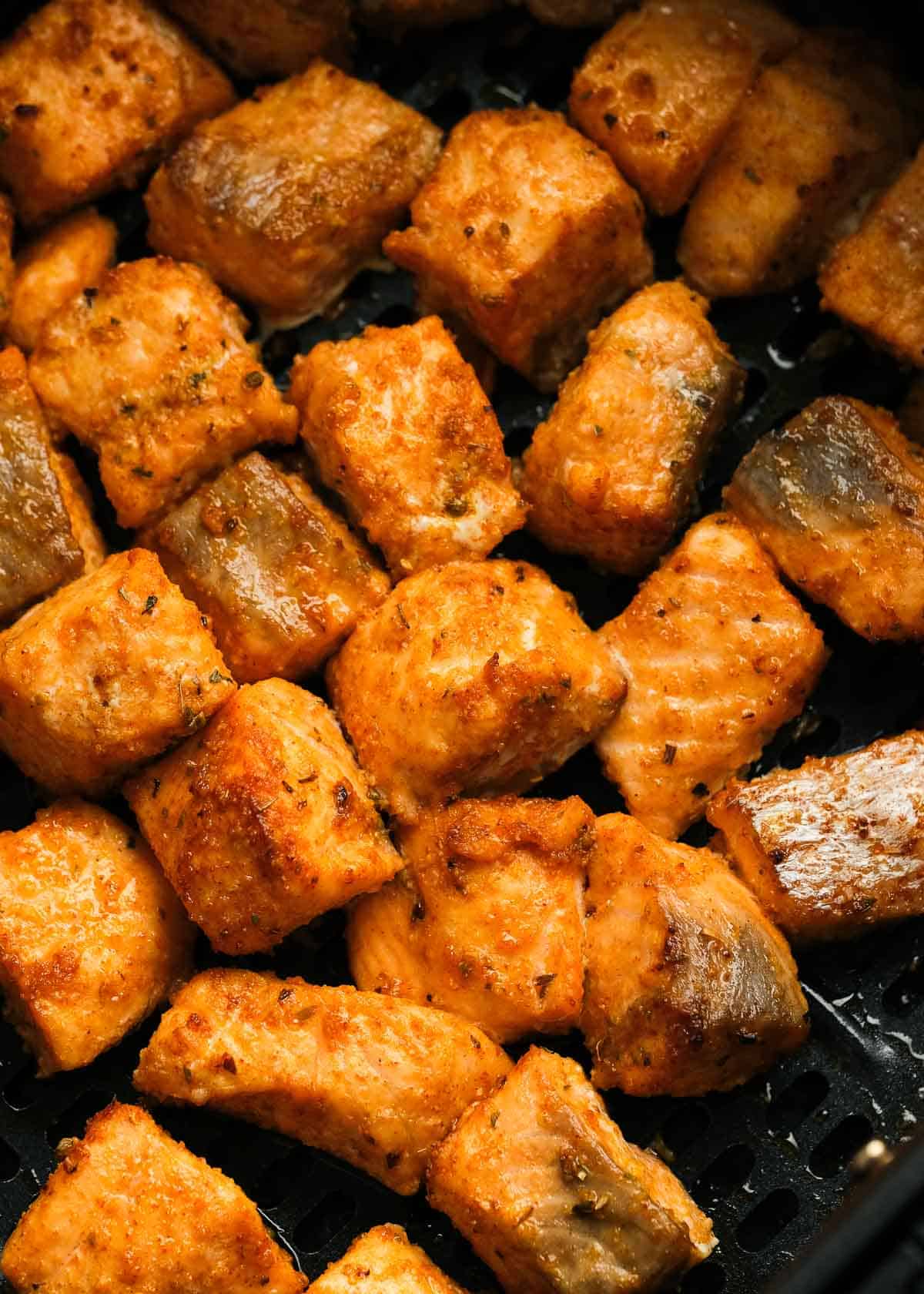 air fryer basket full of perfectly cooked salmon bites