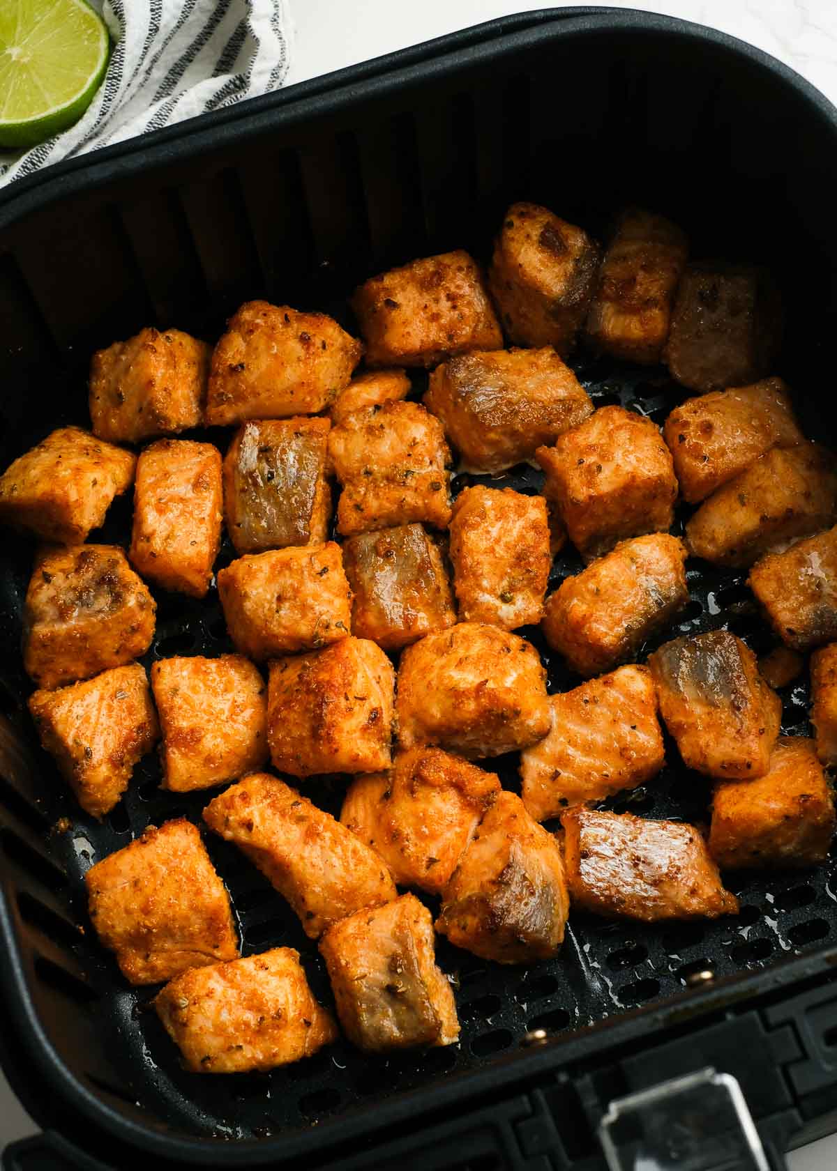 seasoned bites of salmon in an air fryer