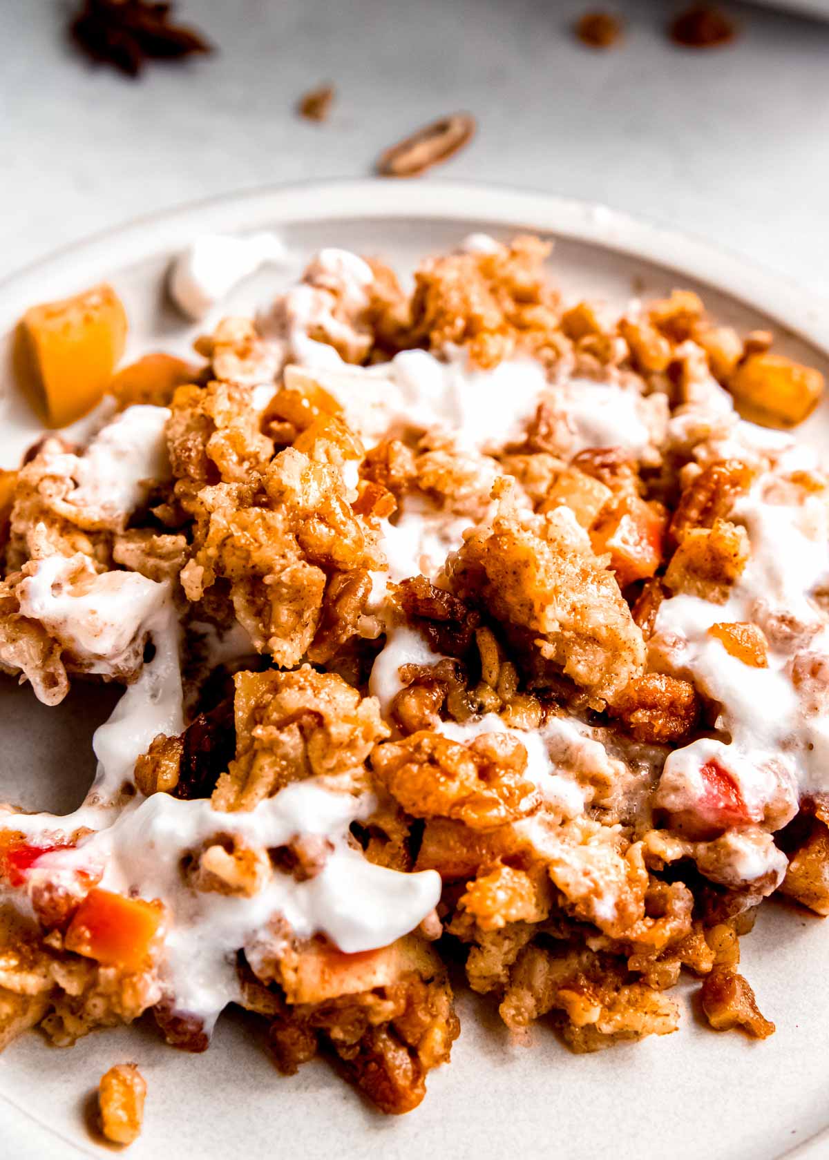 a plate with apple cinnamon baked oatmeal topped with yogurt