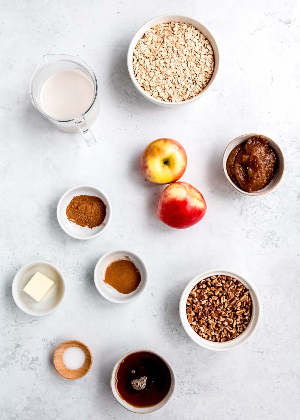 individual ingredients in bowls for apple cinnamon baked oatmeal