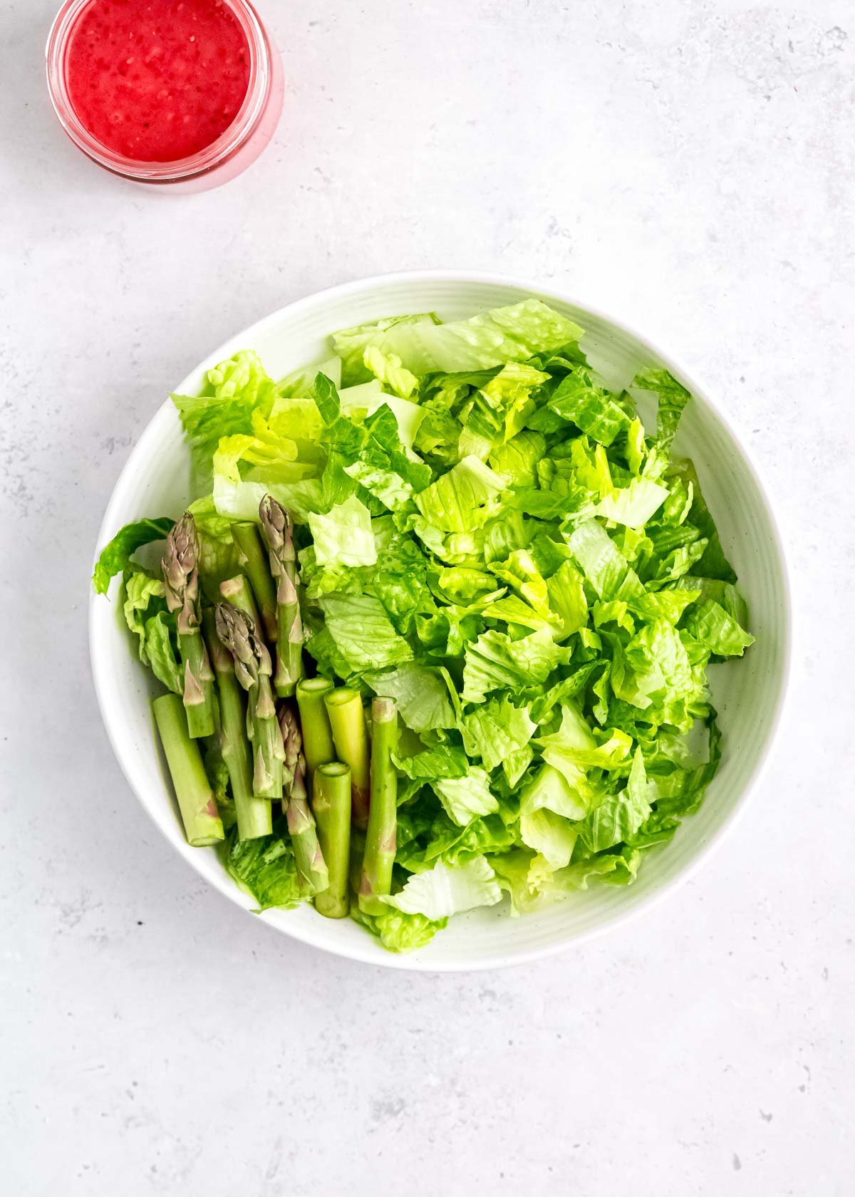 asparagus and lettuce in a white bowl