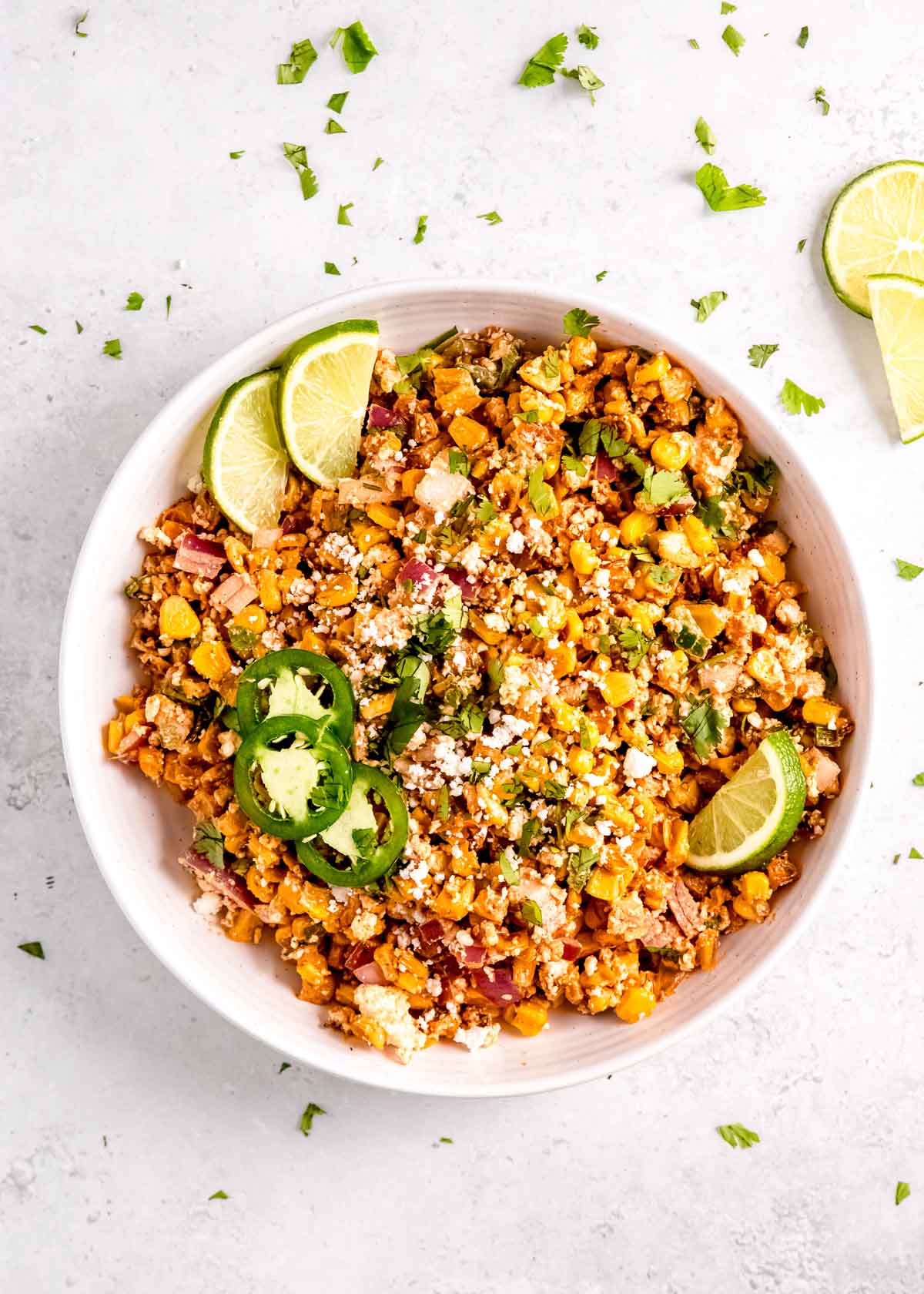 overhead image of Mexican street corn in white bowl