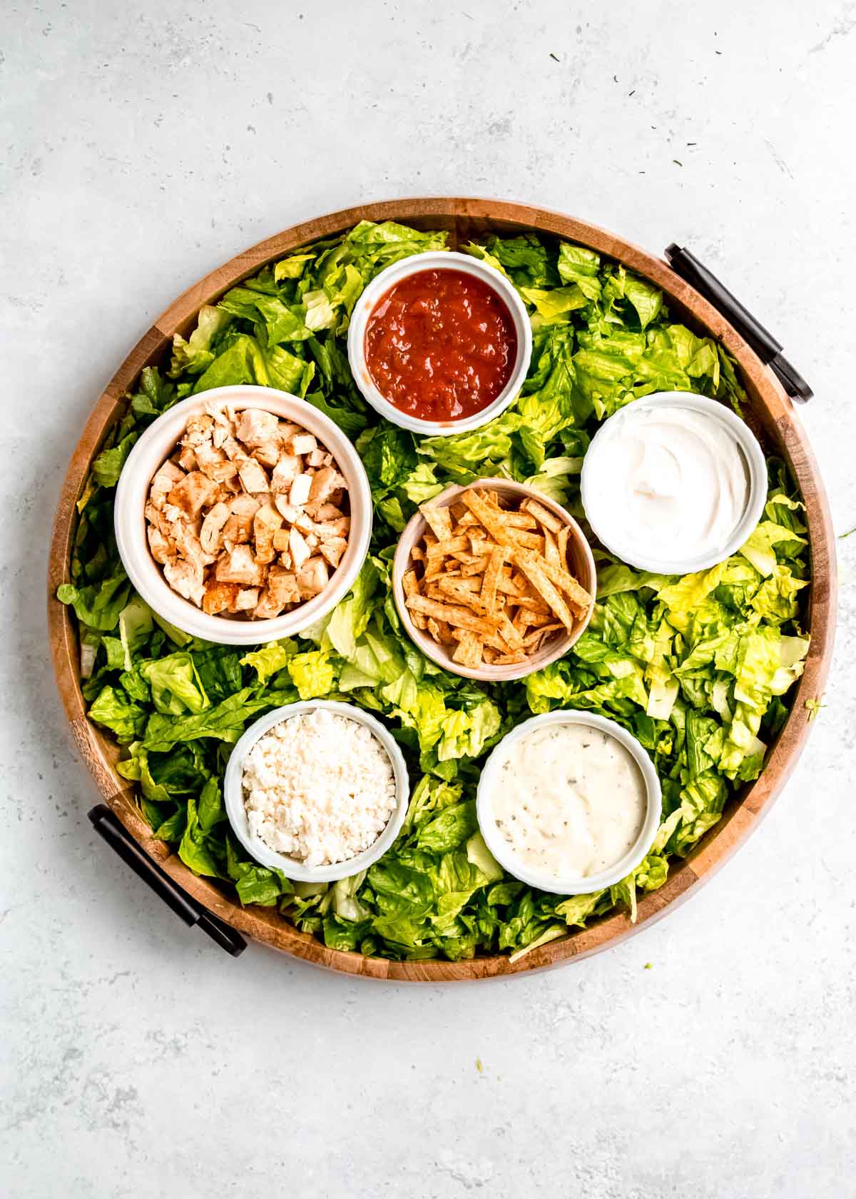 overhead image of lettuce being added to southwest chicken salad