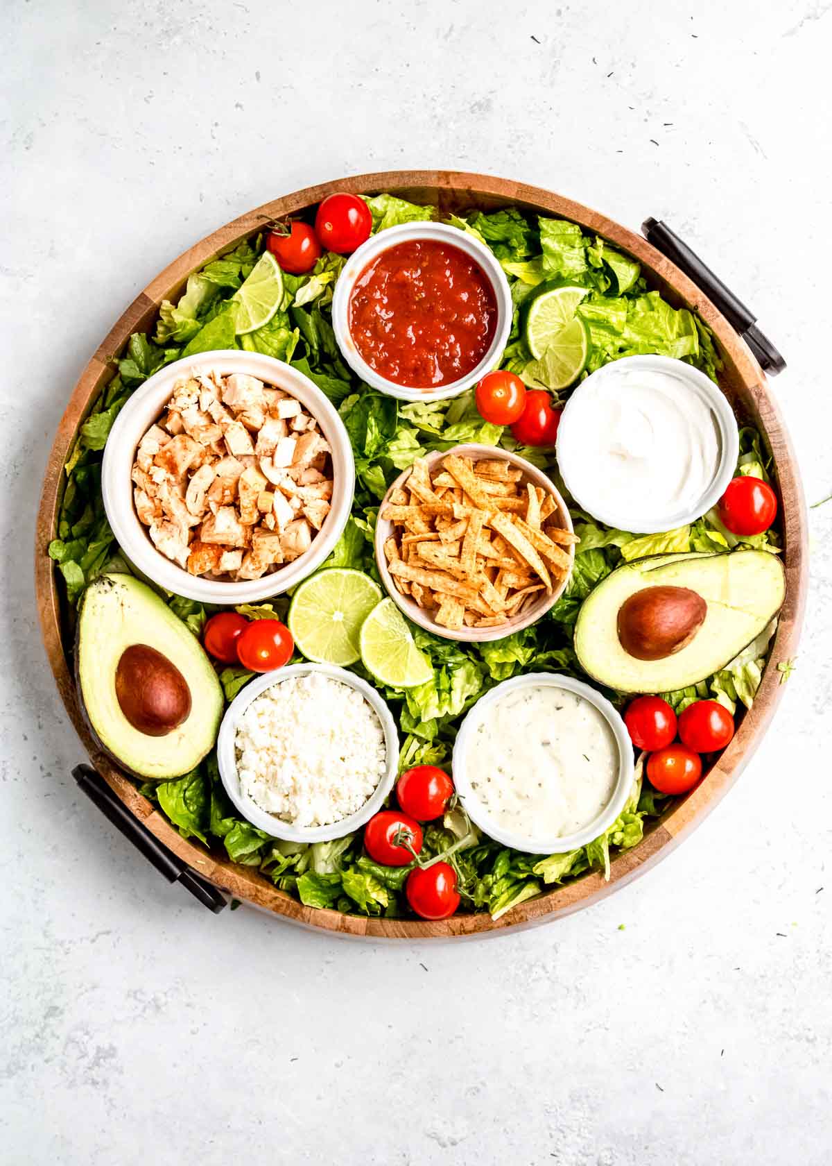 overhead image of avocado being added to southwest chicken salad