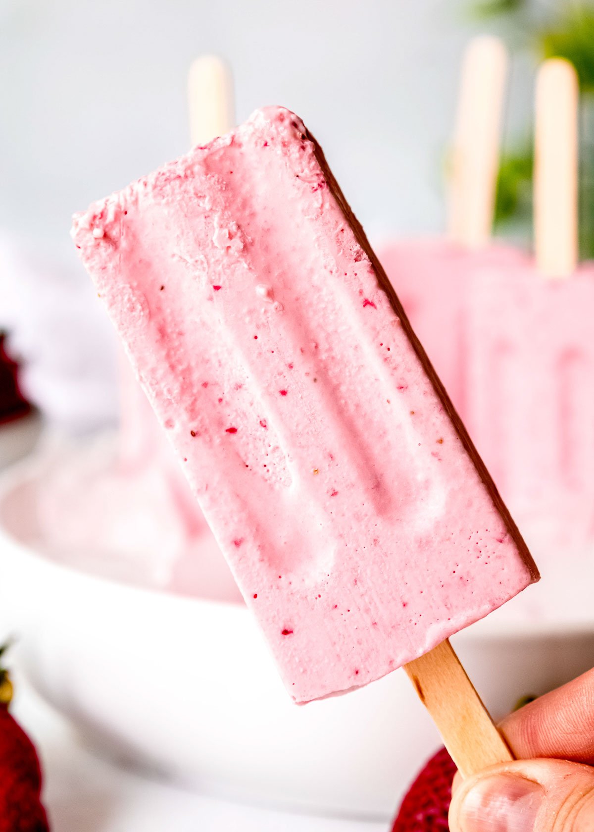 a close up of a strawberry popsicle
