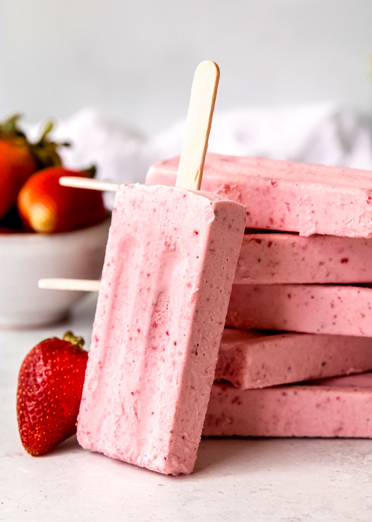 a shot of frozen strawberry ice cream bars with fresh strawberries