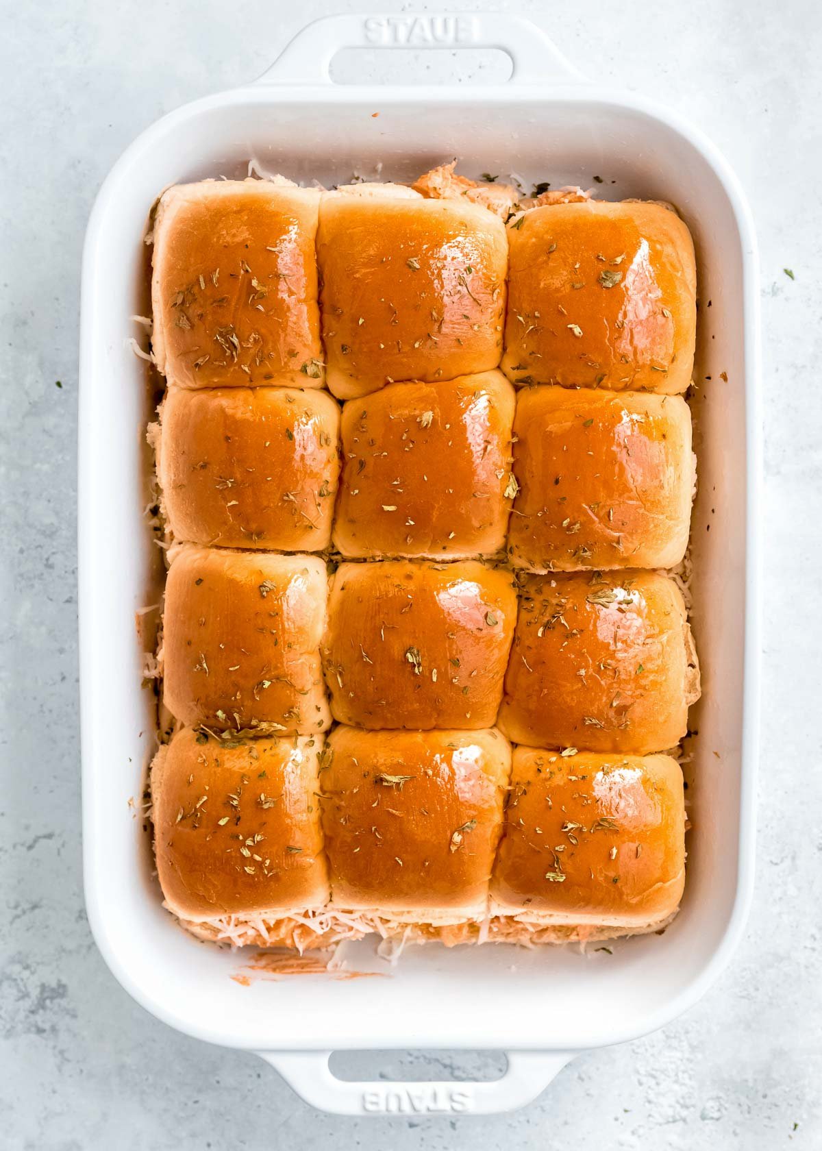 baked buffalo chicken sliders topped with herbs