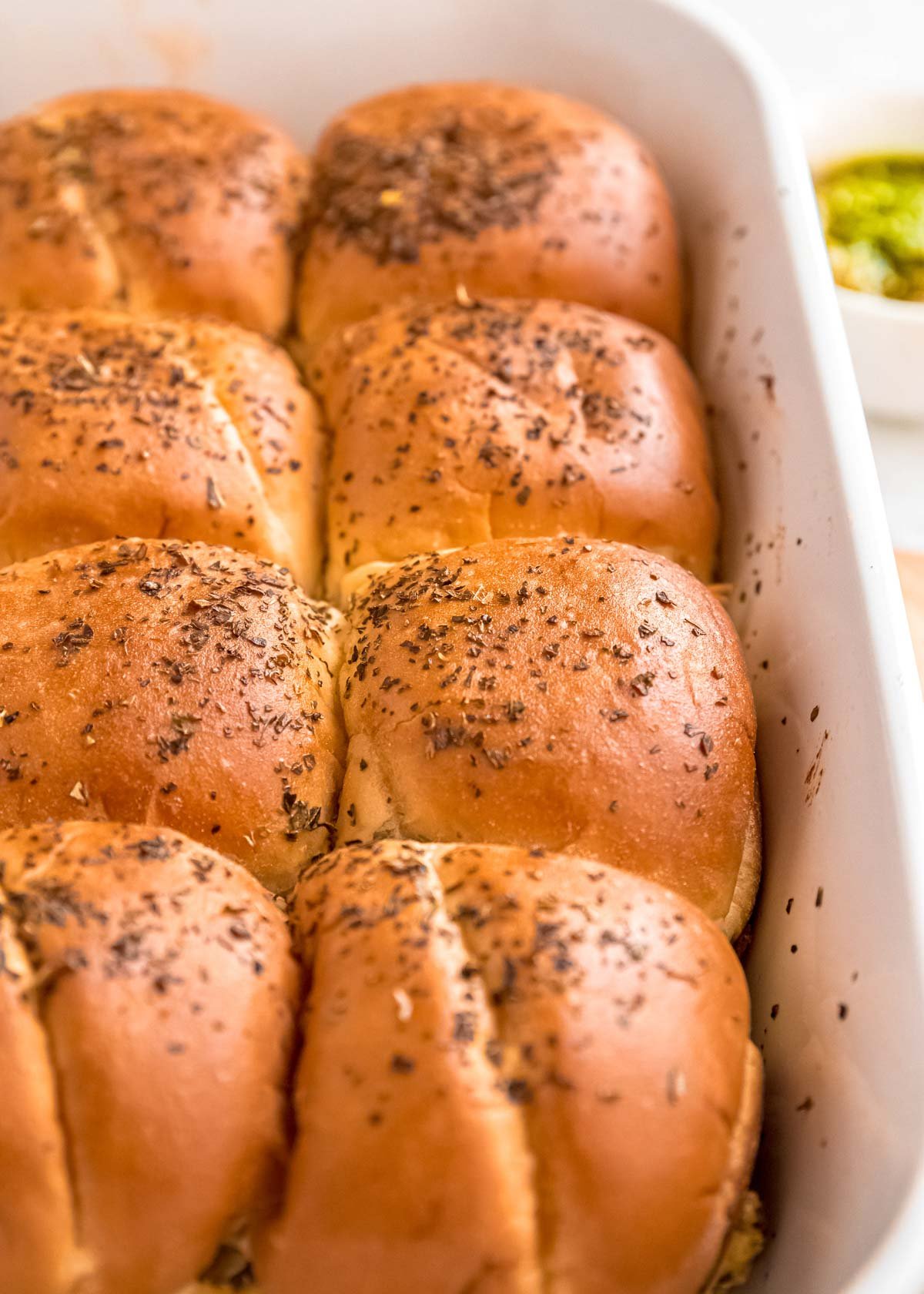 closeup of buttery rolls filled with creamy pesto chicken filling