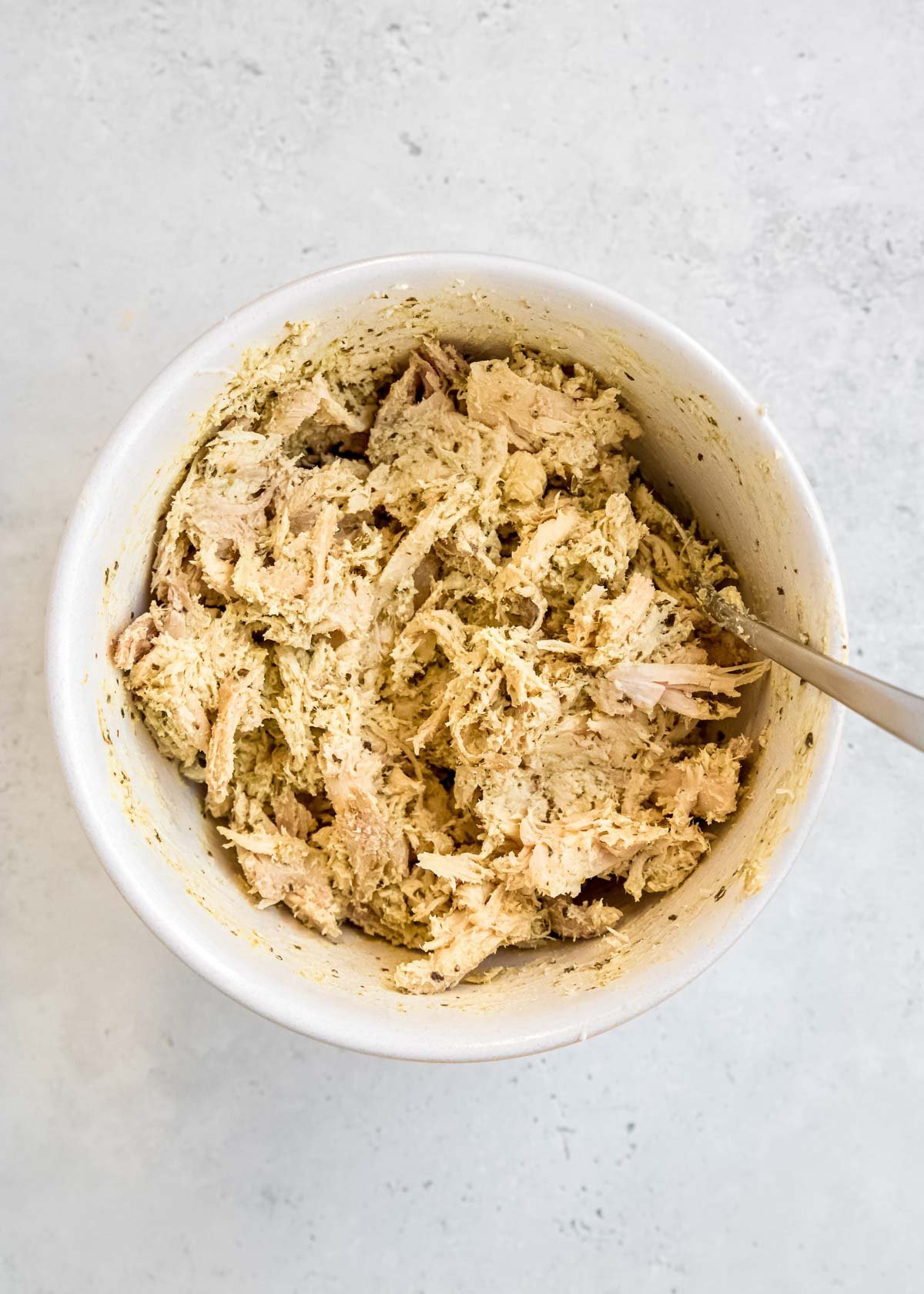 creamy chicken pesto in a white bowl