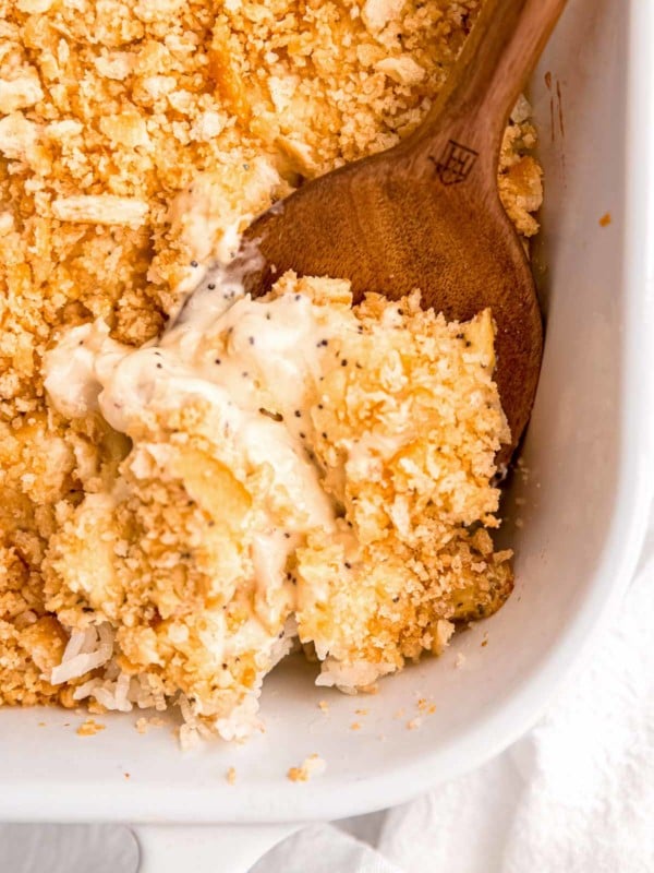 close up image of poppy seed chicken in baking dish