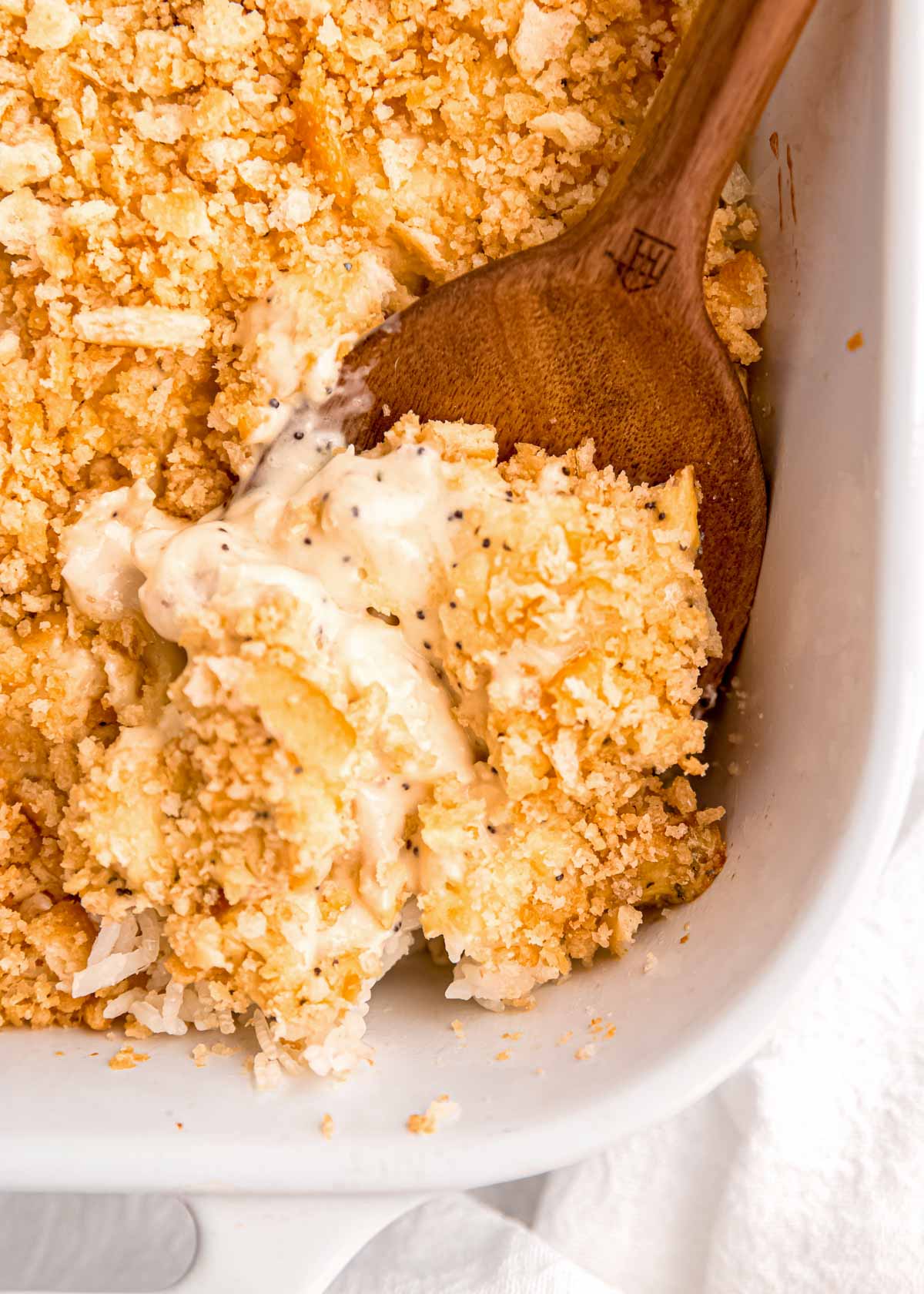 close up image of poppy seed chicken in baking dish