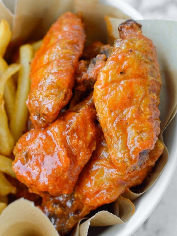 crispy buffalo chicken wings with a side of air fryer french fries