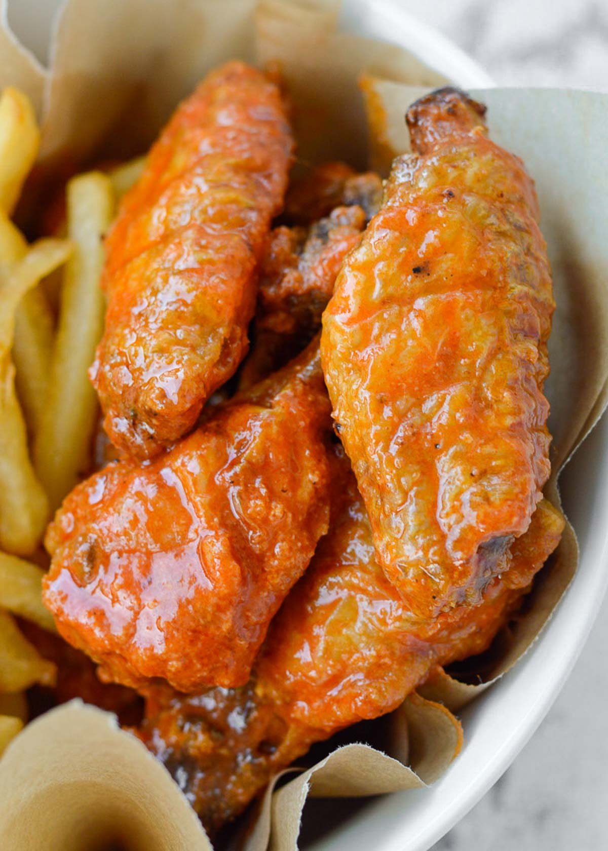 crispy buffalo chicken wings with a side of air fryer french fries