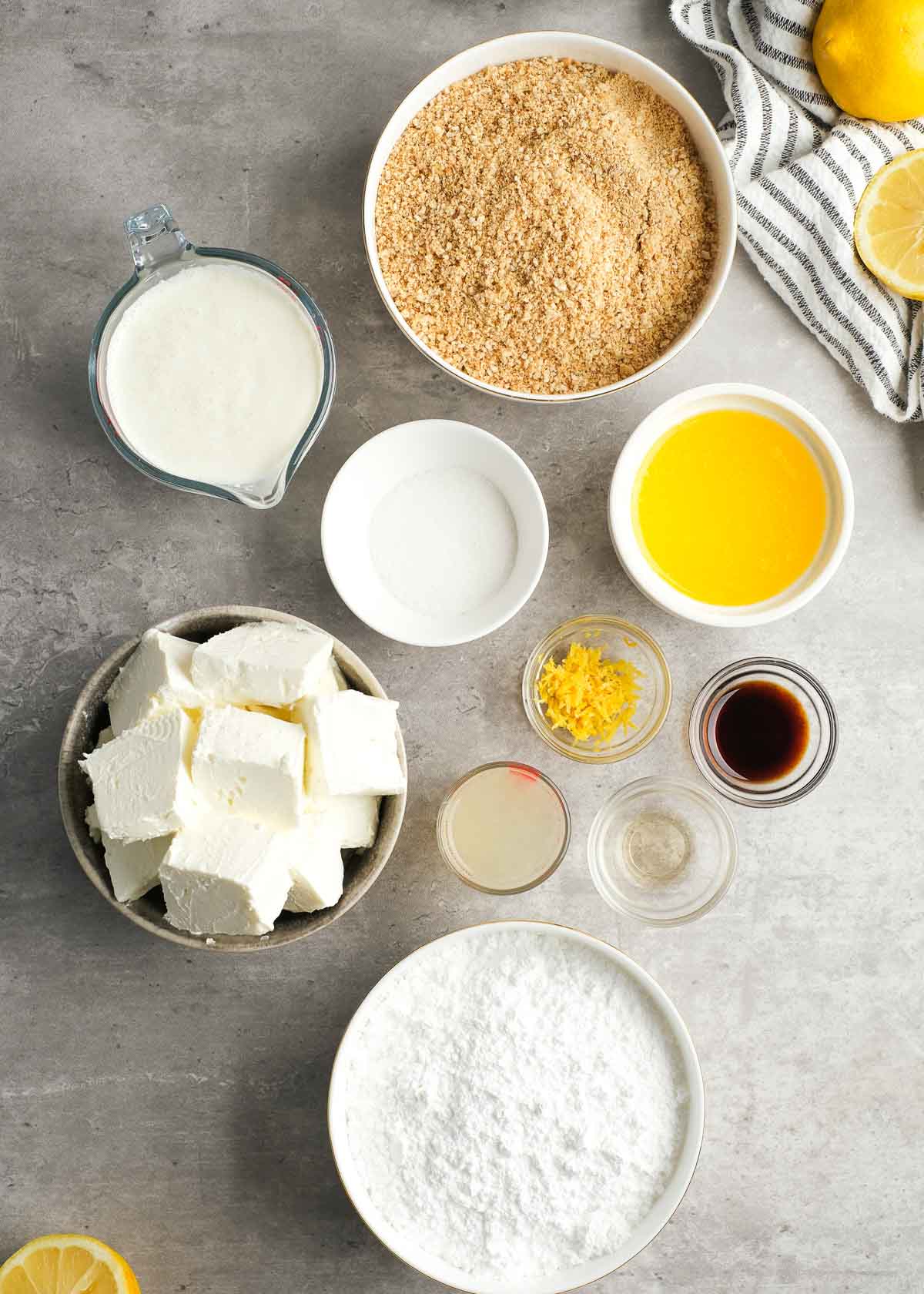 all ingredients needed for a no-bake lemon cheesecake on a countertop