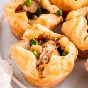 several mini chicken pot pies on a white plate