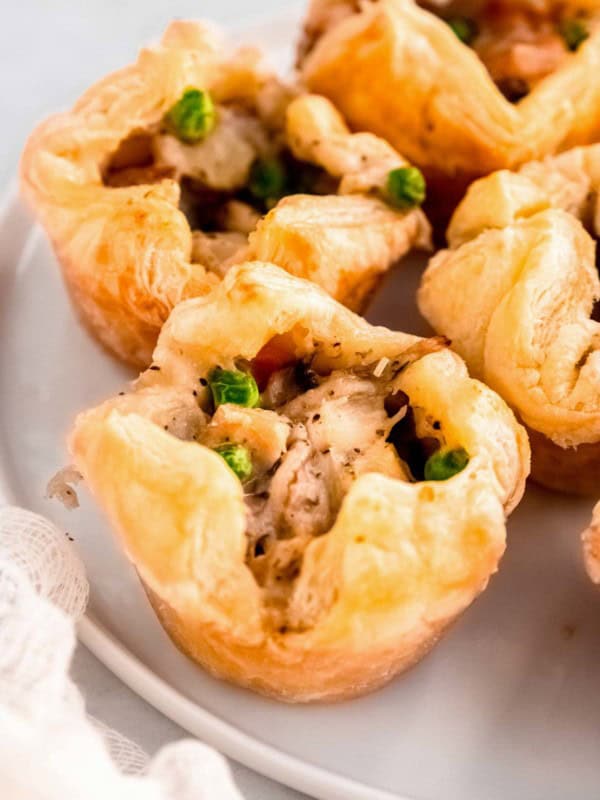 several mini chicken pot pies on a white plate