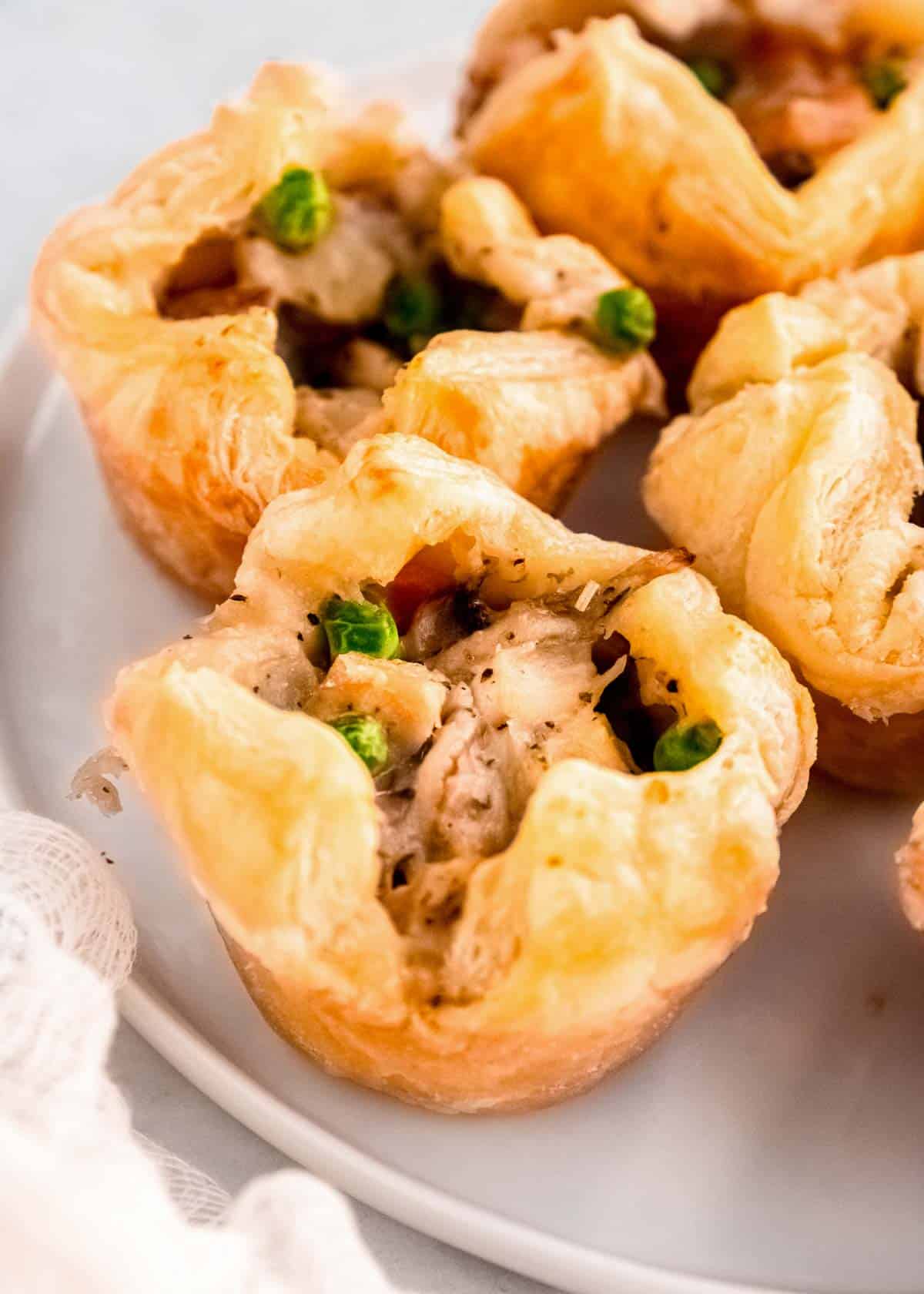 several mini chicken pot pies on a white plate