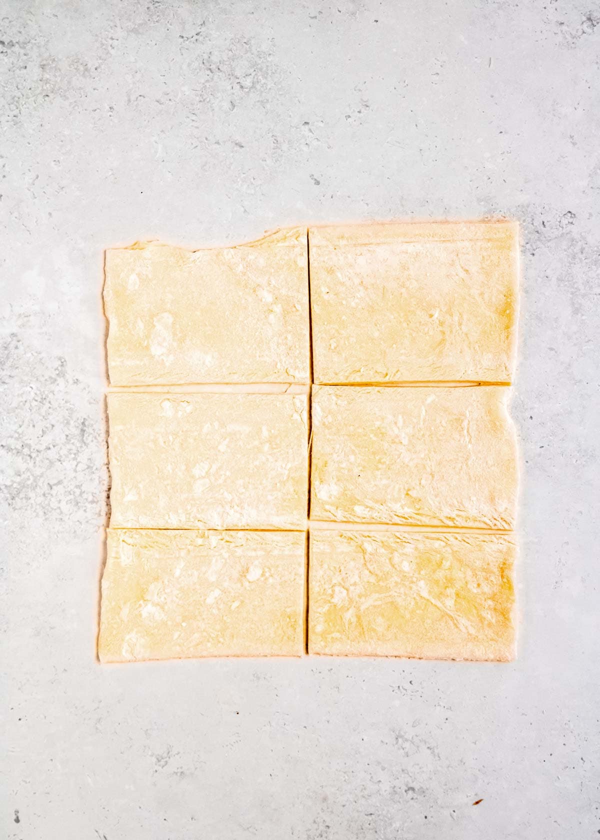 one sheet of puff pastry rolled out and separated into six rectangles