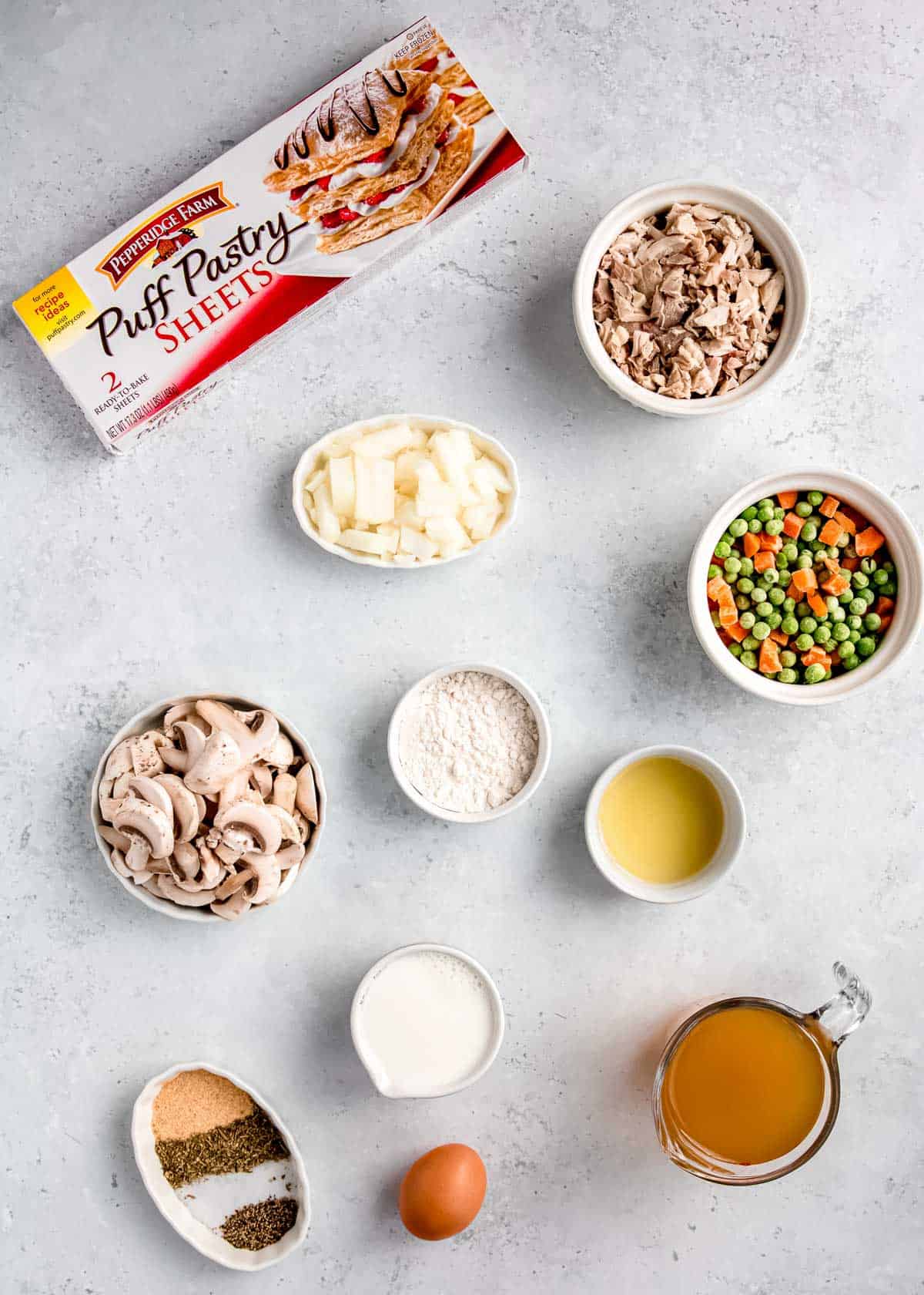 all ingredients needed for mini chicken pot pies on a gray counter