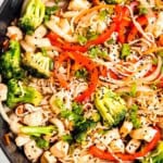 a large skillet filled with broccoli, red bell pepper, onion, chicken, and shirataki noodles for a quick 30-minute stir fry