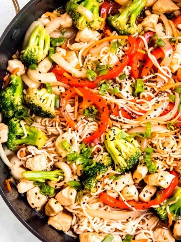 a large skillet filled with broccoli, red bell pepper, onion, chicken, and shirataki noodles for a quick 30-minute stir fry