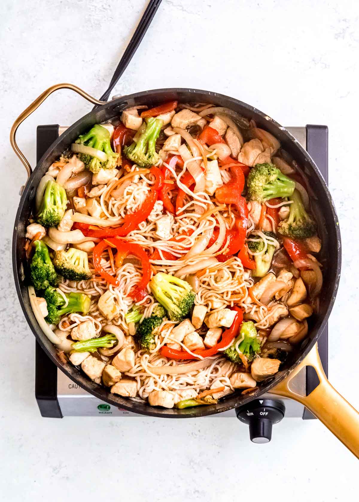 stir fry sauce stirred into the shirataki noodles, chicken, and sauteed vegetables