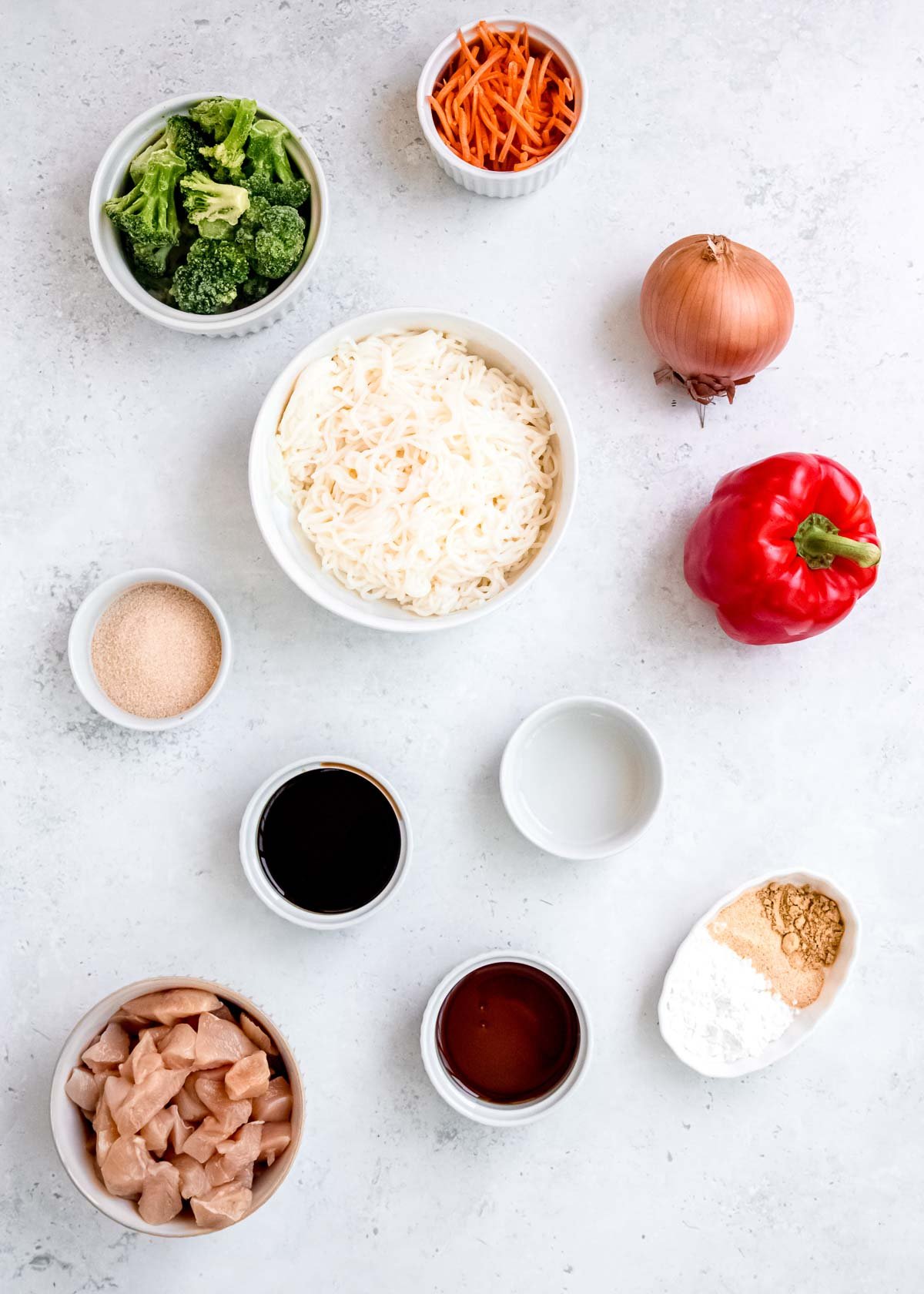 all ingredients needed for shirataki stir fry on a white background