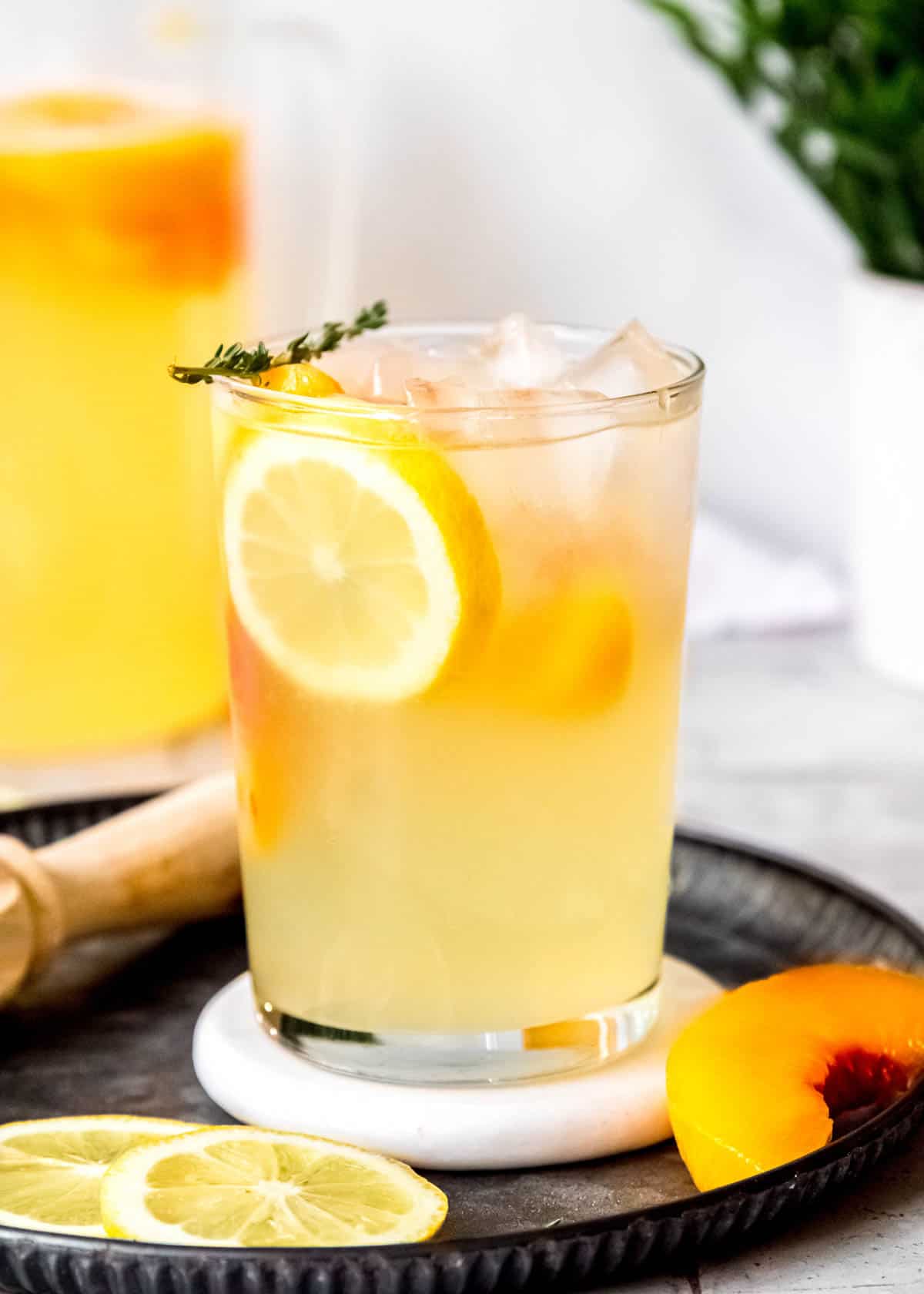 a fresh glass of homemade boozy peach lemonade
