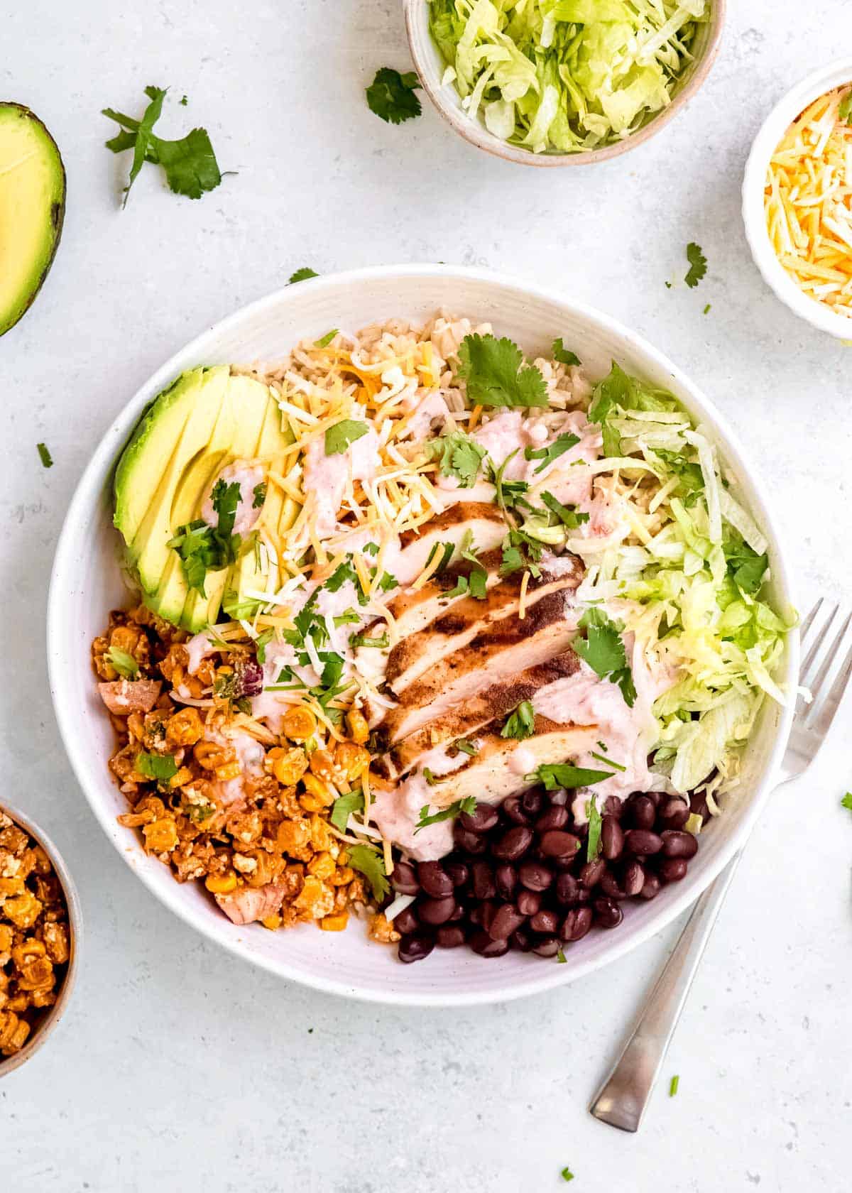 a packed bowl full of Mexican Street Corn Salad taco bowl ingredients