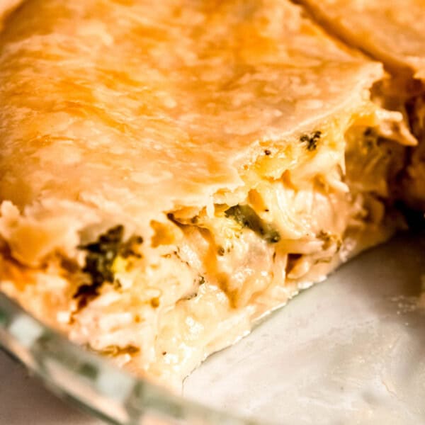 closeup shot showing the creamy broccoli cheddar chicken filling in the pot pie