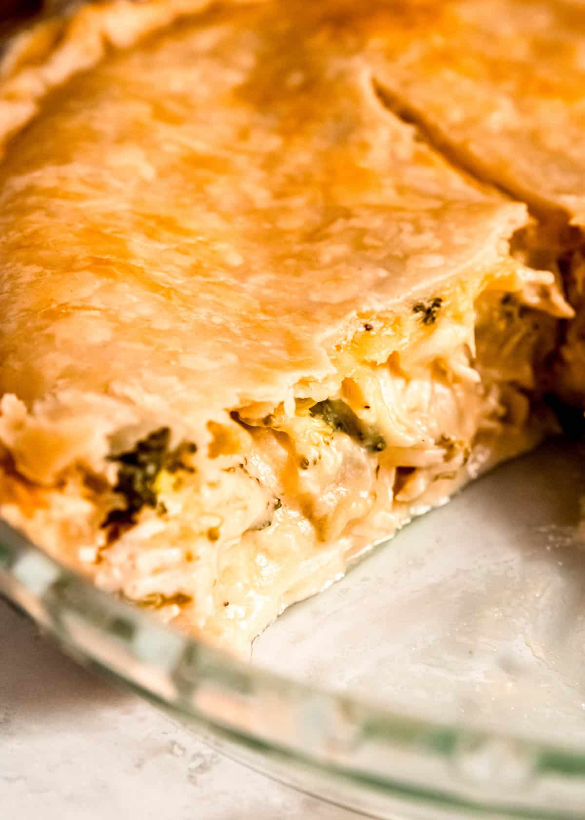 closeup shot showing the creamy broccoli cheddar chicken filling in the pot pie