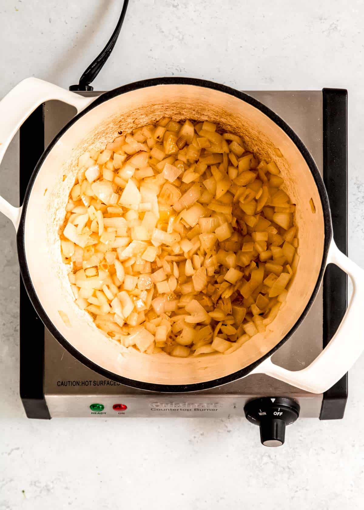 diced onions sauteing in butter in a pot