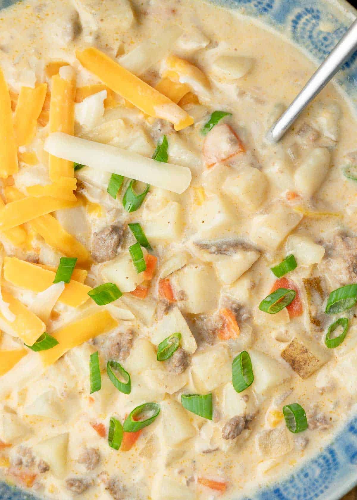 overhead closeup shot showing the tender veggies and juicy ground beef in this hamburger soup