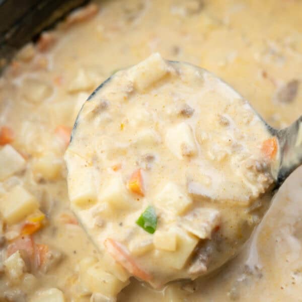 a ladle filled with creamy hamburger potato soup