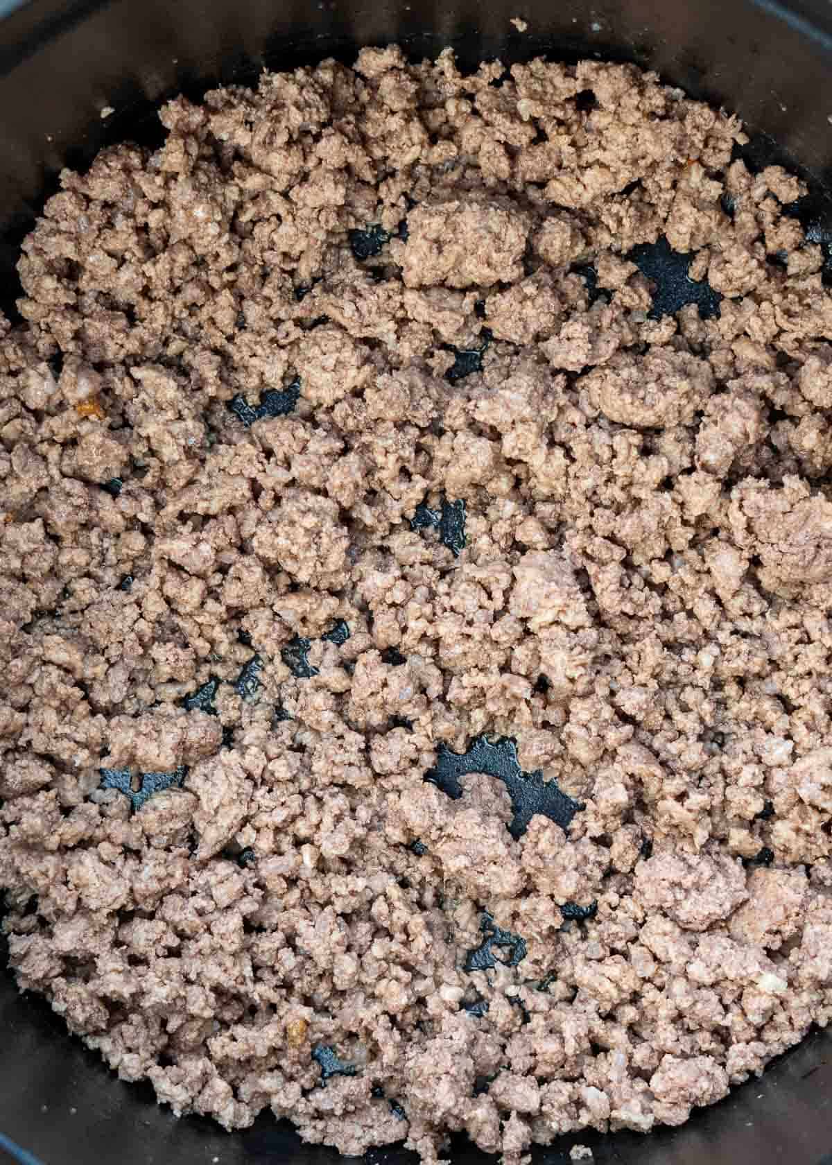 ground beef browned in a cast iron dutch oven