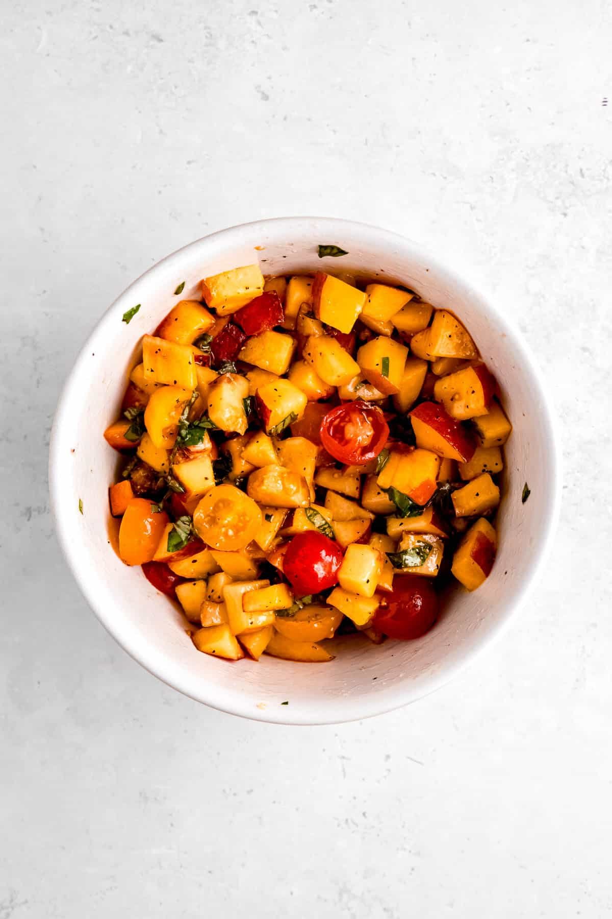 fresh basil mixed with chopped cherry tomatoes and peaches