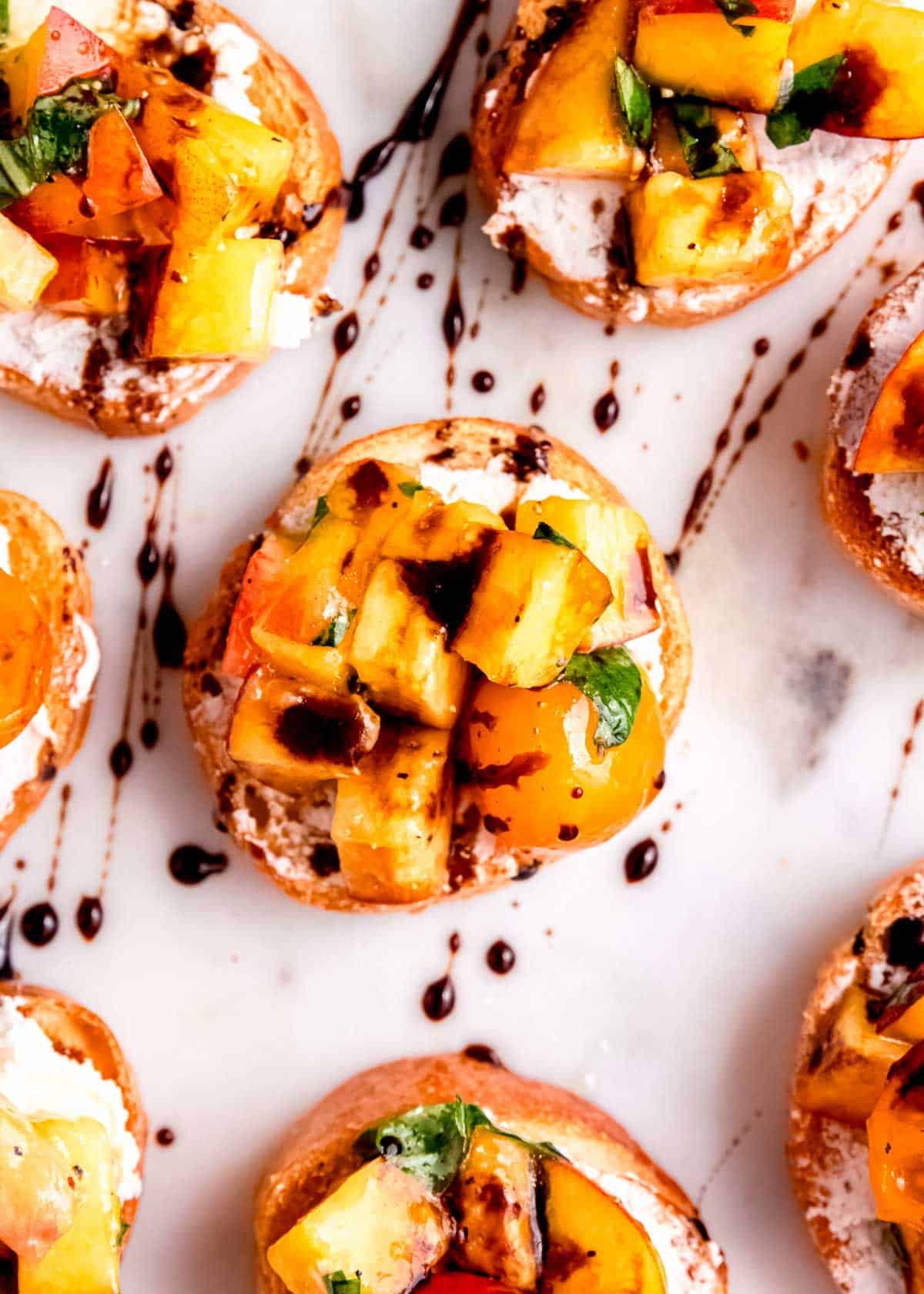 overhead shots showing bruschetta toasts with goat cheese, peaches, and tomatoes