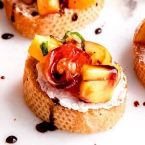 This amazing peach bruschetta is topped with a drizzle of balsamic glaze.