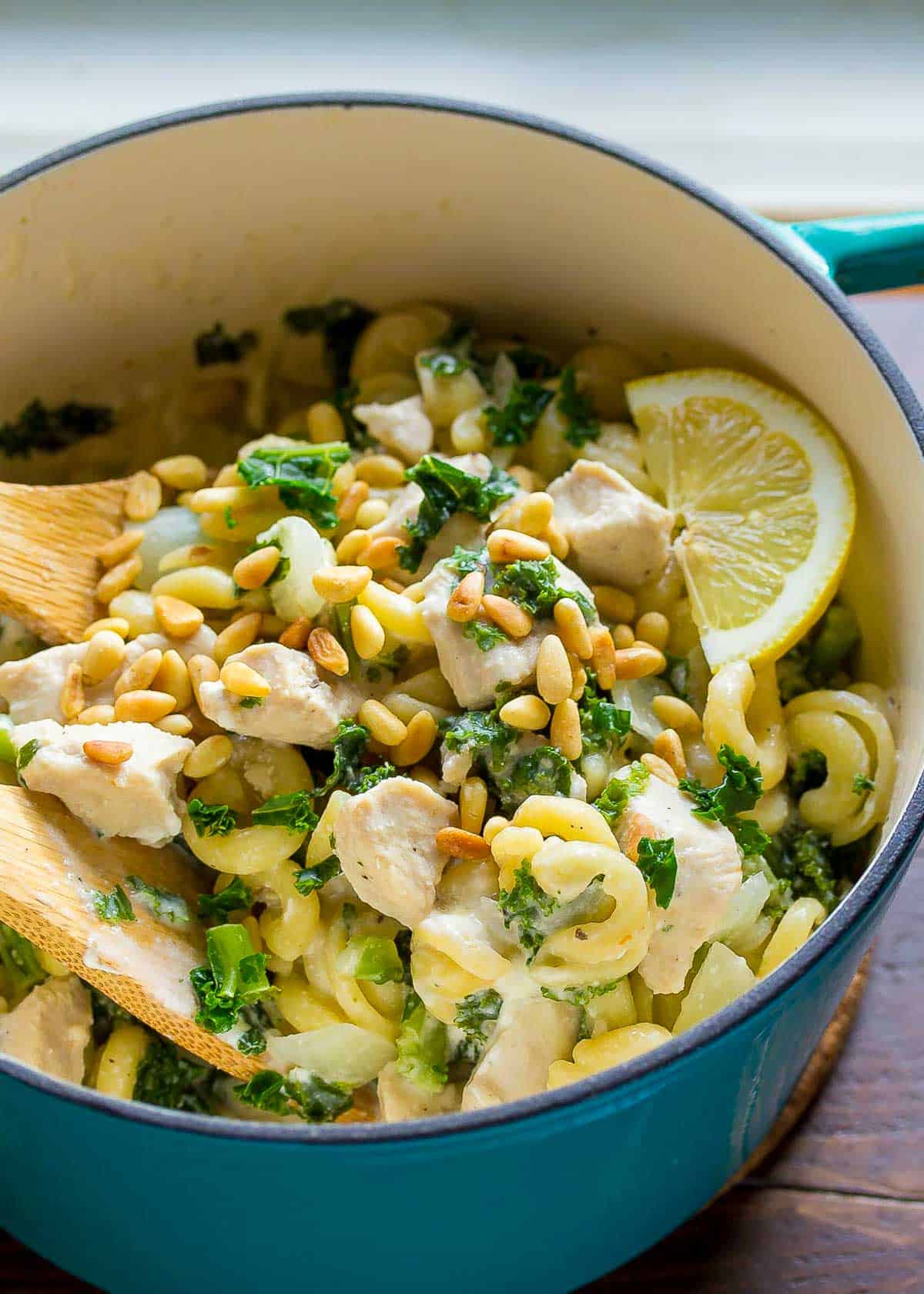pine nuts over a one pot pasta with goat cheese, kale, onion, and lemon juice